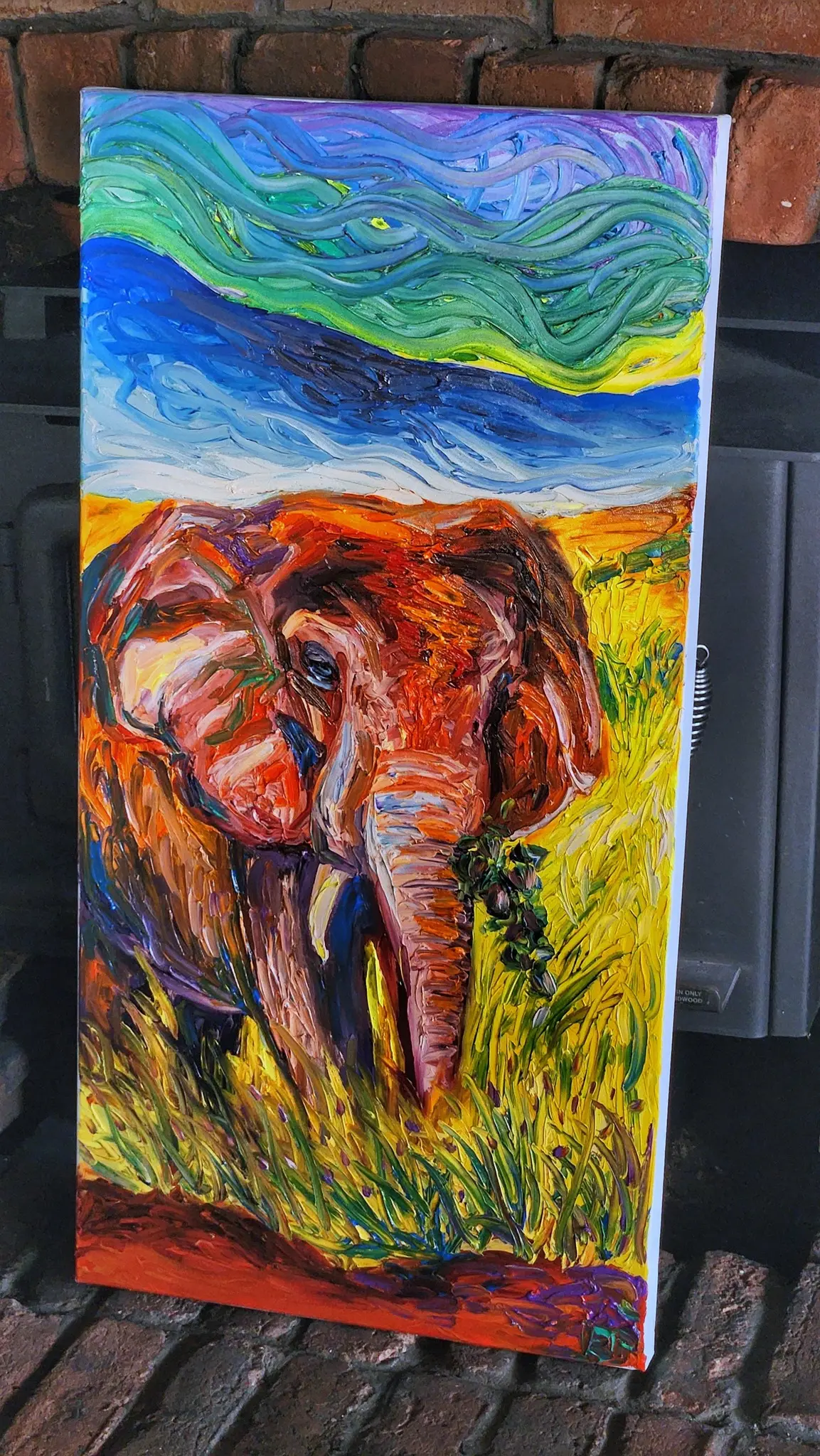 Vibrant painting of an elephant in colorful grass