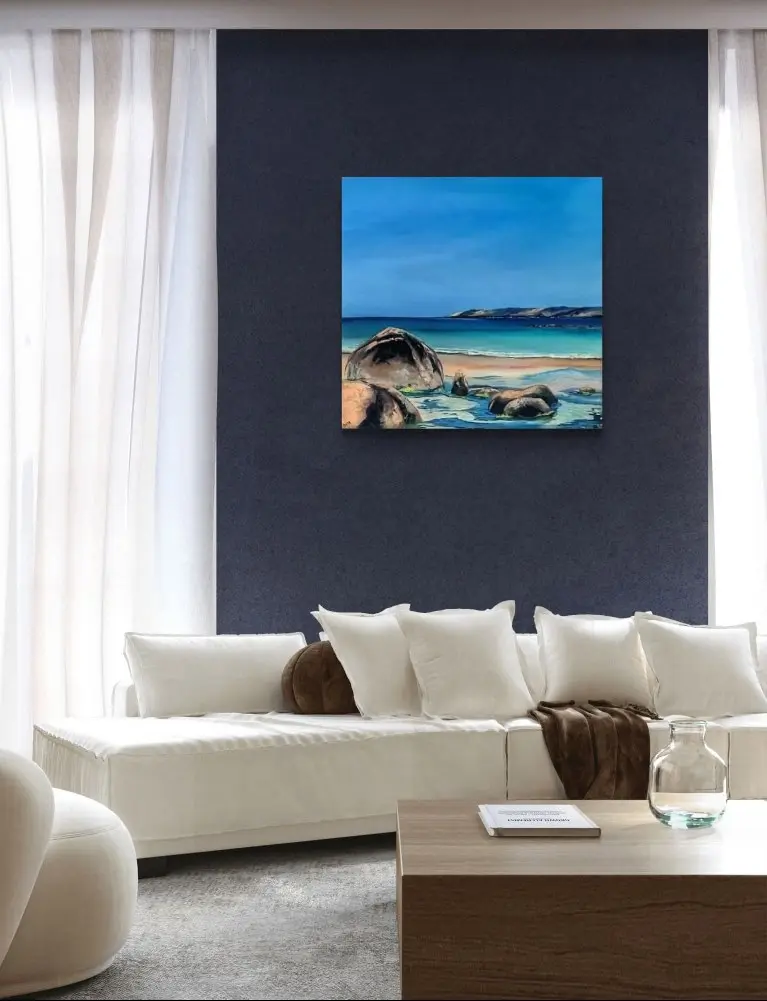 Modern living room with coastal artwork on navy wall