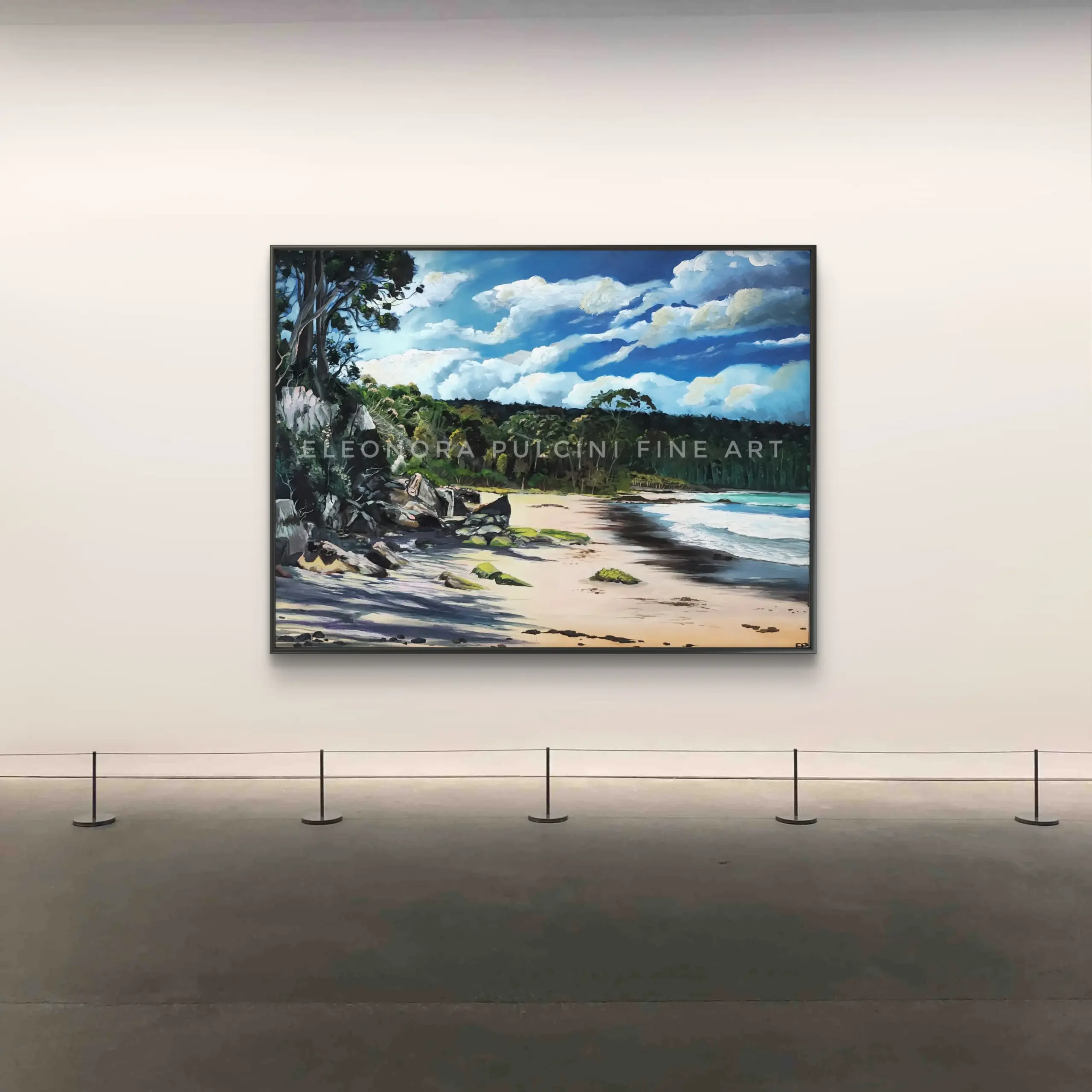 Framed coastal landscape painting in gallery setting