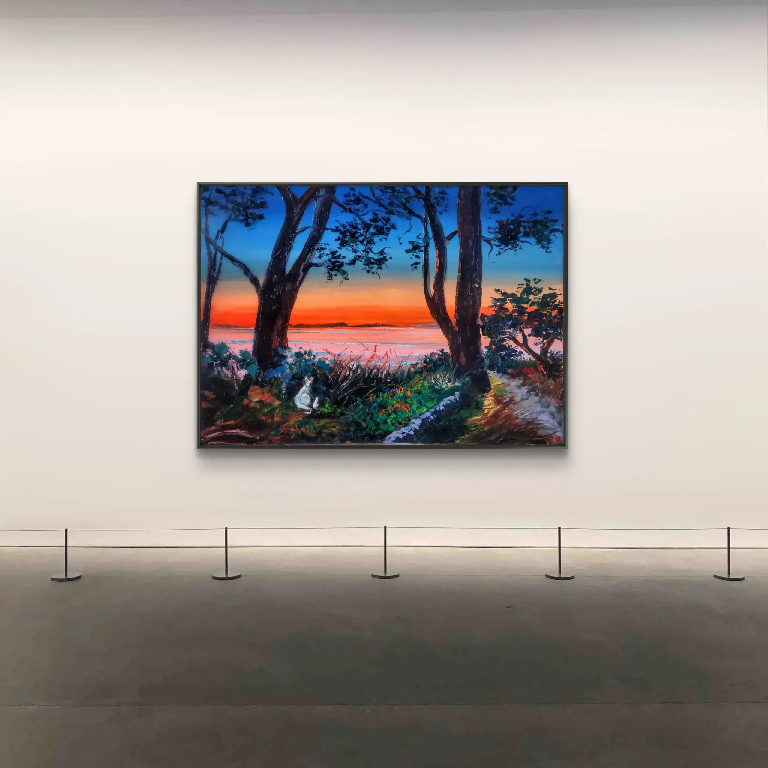 Framed coastal sunset painting in gallery