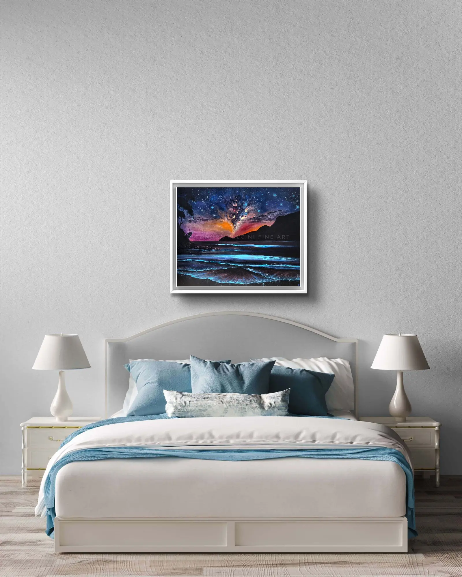 Framed night sky ocean artwork above modern bed