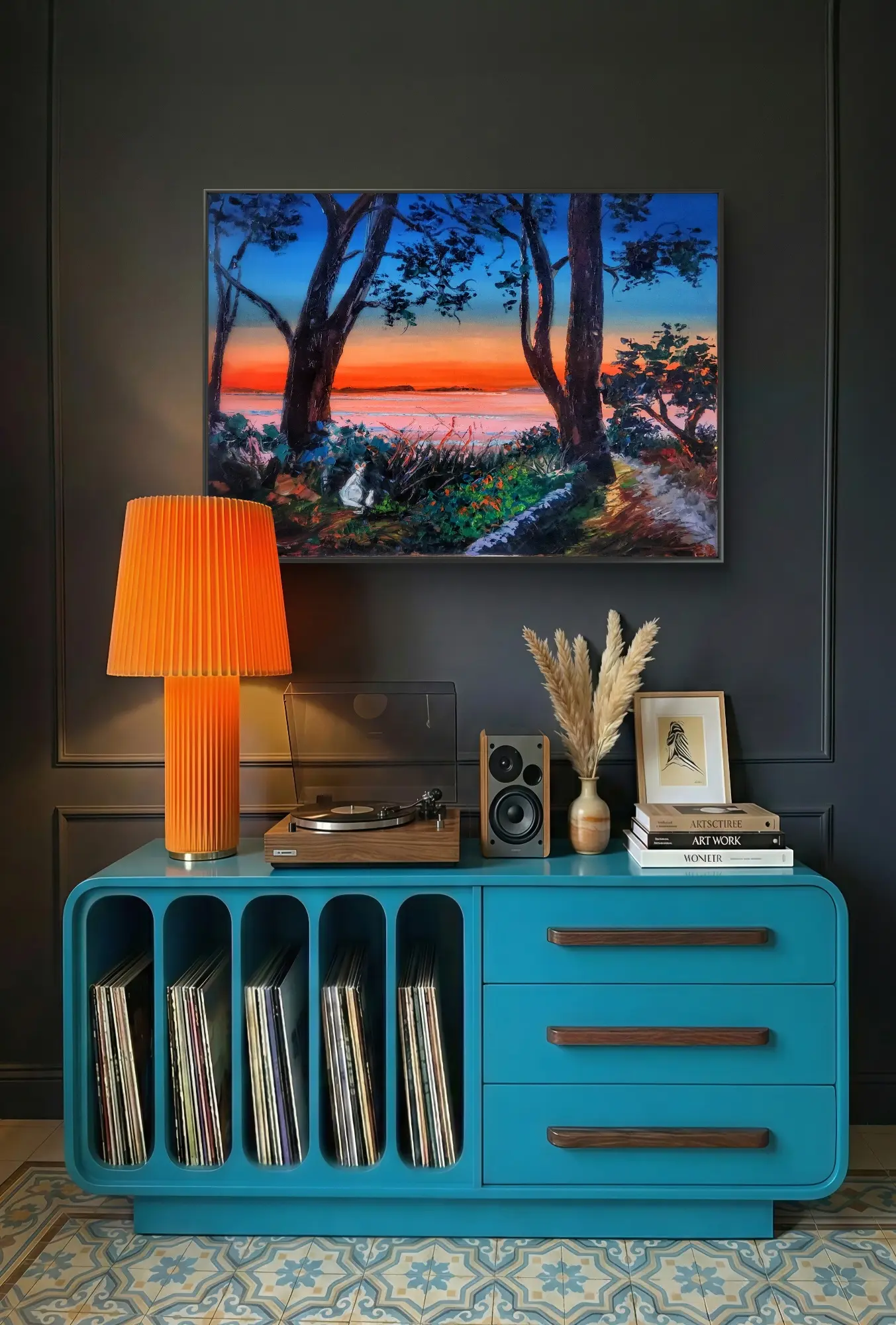 Teal cabinet with turntable beneath sunset painting