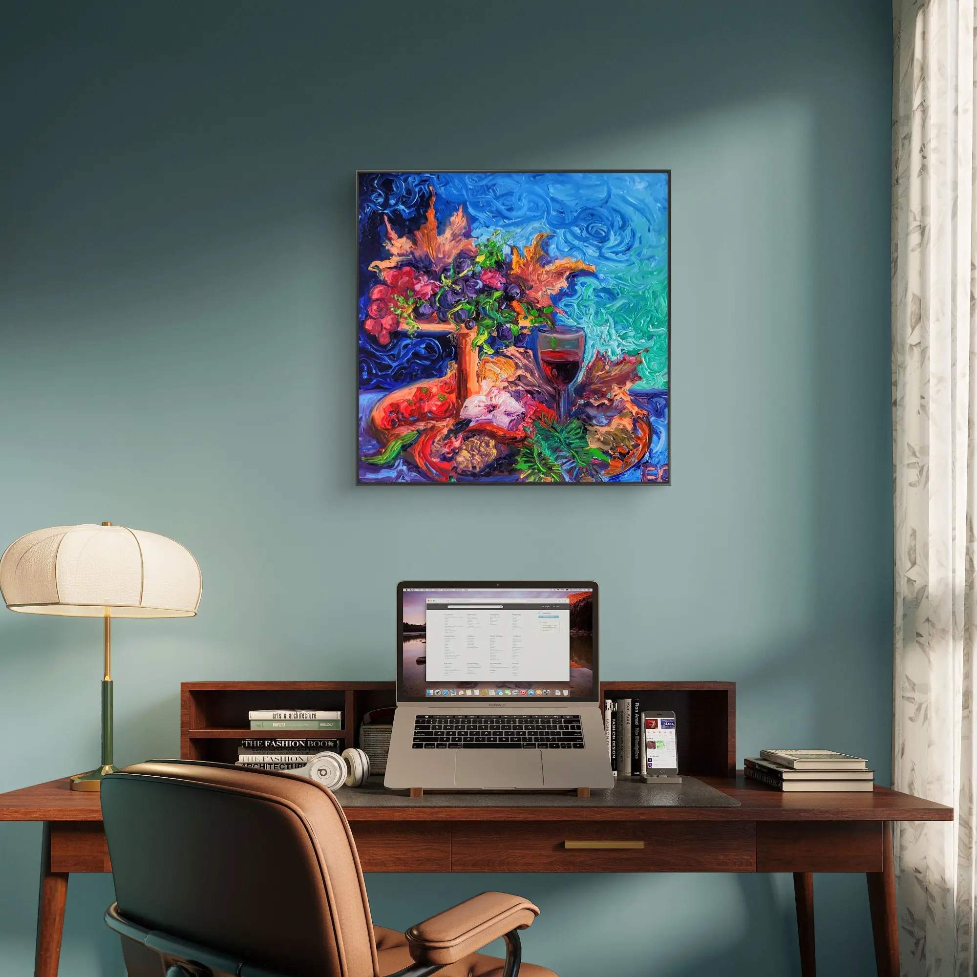 Home office desk with laptop and colourful painting