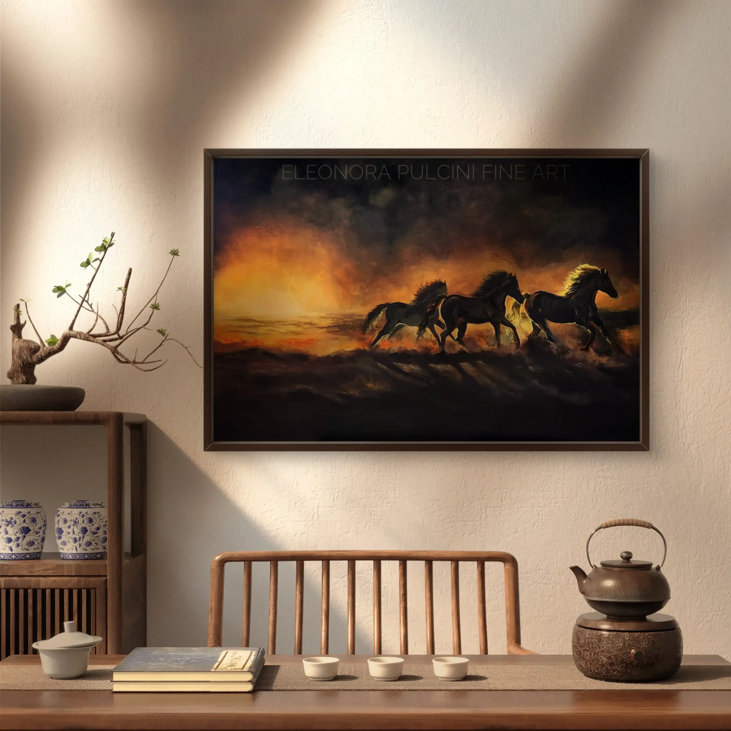 Framed painting of horses running at sunset