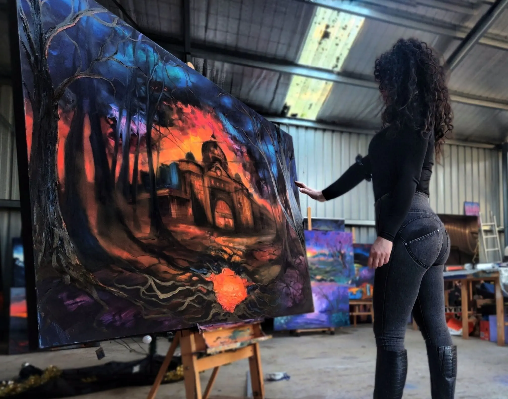 745084619 1974610039856836 1583234901799670296 n Artist viewing large sunset landscape painting in studio